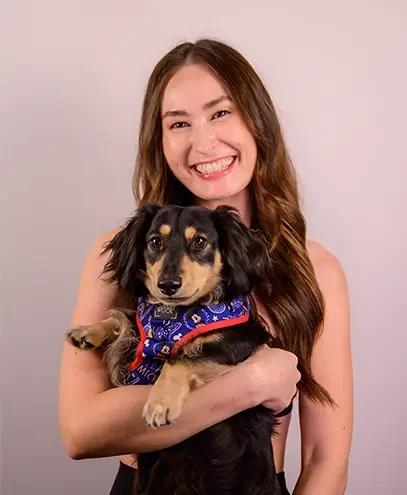 Natalie, fitness instructor at Salt + Burn Studio in Kakaʻako Honolulu, holding Dante